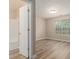 Bright bedroom with natural light, wood-look floors, and attached bathroom with shower and tub combination at 1501 Buckingham, Stockbridge, GA 30281