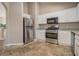 Bright kitchen with stainless steel appliances, granite countertops, and white cabinets at 1501 Buckingham, Stockbridge, GA 30281