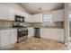 Well-lit kitchen with stainless steel appliances, granite countertops, and ample cabinet space at 1501 Buckingham, Stockbridge, GA 30281