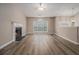 Spacious living room with a fireplace, vaulted ceilings, and large windows at 1501 Buckingham, Stockbridge, GA 30281
