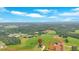 Pictureque aerial shot of a new home on a verdant lot surrounded by lush trees and rolling hillsides at 152 Palisade Dr, Rydal, GA 30171