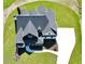 Aerial view of a two-story home with an intricate roofline, white driveway, and lush landscaping at 152 Palisade Dr, Rydal, GA 30171