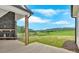 Covered patio with stone fireplace overlooking a spacious backyard and picturesque landscape at 152 Palisade Dr, Rydal, GA 30171
