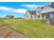 Expansive backyard and exterior view of the white, modern farmhouse style home at 152 Palisade Dr, Rydal, GA 30171