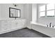 Bright bathroom featuring a soaking tub, black fixtures and a spacious white vanity at 152 Palisade Dr, Rydal, GA 30171
