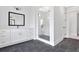 Bright bathroom featuring a glass shower with black fixtures and a spacious white vanity at 152 Palisade Dr, Rydal, GA 30171