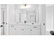 Modern bathroom with a large mirror, white cabinets, and sleek black hardware at 152 Palisade Dr, Rydal, GA 30171