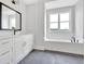 Bright bathroom with white cabinets, black fixtures, and a large soaking tub beneath a window at 152 Palisade Dr, Rydal, GA 30171