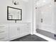 Bright bathroom featuring a glass shower with black fixtures and a spacious white vanity at 152 Palisade Dr, Rydal, GA 30171