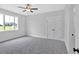Bedroom features neutral walls and carpet, a ceiling fan, a double door closet, and a bright window at 152 Palisade Dr, Rydal, GA 30171