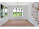 Dining room features hardwood floors, view to exterior, and staircase at 152 Palisade Dr, Rydal, GA 30171