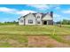 View of home from backyard showcasing large yard and modern farmhouse style at 152 Palisade Dr, Rydal, GA 30171