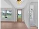 Inviting foyer with hardwood floors, leading to an open-concept living space and large windows at 152 Palisade Dr, Rydal, GA 30171
