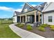Inviting front porch with stone pillars and wood posts, complemented by manicured landscaping at 152 Palisade Dr, Rydal, GA 30171