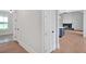 Hallway leading to modern living space featuring a fireplace and kitchen with an island at 152 Palisade Dr, Rydal, GA 30171