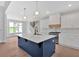 Kitchen with center island with sink, white cabinets, and stainless steel appliances at 152 Palisade Dr, Rydal, GA 30171