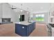 Spacious open concept kitchen with island, stone fireplace, and stainless steel appliances at 152 Palisade Dr, Rydal, GA 30171