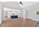 Open-concept living area featuring hardwood floors, a kitchen island, and modern appliances at 152 Palisade Dr, Rydal, GA 30171