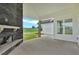 Covered patio featuring a stone fireplace and views of the expansive backyard at 152 Palisade Dr, Rydal, GA 30171
