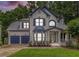 Attractive two-story home with manicured lawn, beautiful porch, and a two-car garage, nestled in lush greenery at 2804 Stillwater Park Dr, Marietta, GA 30066