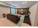 Cozy living room features recessed lighting, brown couches, an area rug, and a treadmill for exercise at 2804 Stillwater Park Dr, Marietta, GA 30066