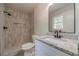 Bathroom featuring tiled shower, granite vanity and upgraded fixtures at 3404 Broxton Mill Way, Snellville, GA 30039