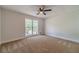 Carpeted bedroom featuring a ceiling fan and large window providing ample natural light at 3404 Broxton Mill Way, Snellville, GA 30039