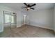 Spacious bedroom with a ceiling fan, closet with mirrored doors and a view to an attached bath at 3404 Broxton Mill Way, Snellville, GA 30039
