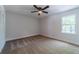 Bedroom with carpet, a ceiling fan, window for natural light, and a closet with bi-fold doors at 3404 Broxton Mill Way, Snellville, GA 30039
