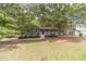 Charming home featuring a welcoming front porch, lush landscaping, and inviting curb appeal at 3404 Broxton Mill Way, Snellville, GA 30039