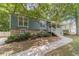 Charming home featuring a welcoming front porch, lush landscaping, and inviting curb appeal at 3404 Broxton Mill Way, Snellville, GA 30039