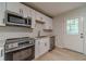 Renovated kitchen with stainless appliances, white cabinetry, and subway tile at 3404 Broxton Mill Way, Snellville, GA 30039