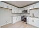 Stylish kitchen with white cabinets, modern appliances, and subway tile backsplash at 3404 Broxton Mill Way, Snellville, GA 30039