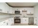 Updated kitchen featuring white cabinets, stainless steel appliances, and granite countertops at 3404 Broxton Mill Way, Snellville, GA 30039
