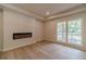Living room featuring fireplace, hardwood floors, and natural light at 3404 Broxton Mill Way, Snellville, GA 30039