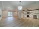Open-concept living room and kitchen area with hardwood floors and modern lighting fixtures at 3404 Broxton Mill Way, Snellville, GA 30039