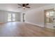 Open-concept living room with hard surface floors and double doors that lead to the back yard at 3404 Broxton Mill Way, Snellville, GA 30039