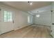 Bright living room with windows, hardwood flooring, and a modern light fixture at 3404 Broxton Mill Way, Snellville, GA 30039