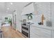 Well-appointed kitchen with white cabinets, herringbone backsplash, and stainless steel appliances at 70 Old Ivy Ne Rd # 57, Atlanta, GA 30342