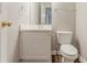 Bathroom with a toilet and a vanity featuring a white countertop and cabinet at 257 Turnstone Rd, Stockbridge, GA 30281
