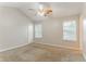 Bright bedroom featuring neutral walls, carpeted floor, ceiling fan, and natural light from two windows at 257 Turnstone Rd, Stockbridge, GA 30281