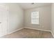 Bedroom with carpeted floors, one window, and neutral paint at 257 Turnstone Rd, Stockbridge, GA 30281