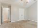 A neutral bedroom space showcasing soft carpet, airy windows, and an easy access closet at 257 Turnstone Rd, Stockbridge, GA 30281