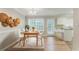Bright dining area with hardwood floors, a modern light fixture, and large windows for natural light at 257 Turnstone Rd, Stockbridge, GA 30281