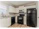 Well-lit kitchen with white cabinetry and modern black appliances at 257 Turnstone Rd, Stockbridge, GA 30281