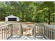 Spacious backyard and detached garage viewed from a wooden deck at 2871 Tucker Mill Sw Rd, Conyers, GA 30094