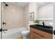 Elegant bathroom with sleek black countertops, modern fixtures, and a stylish vanity at 2871 Tucker Mill Sw Rd, Conyers, GA 30094