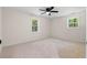 Bright bedroom with neutral walls, a ceiling fan, and large windows at 2871 Tucker Mill Sw Rd, Conyers, GA 30094