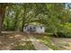 Charming one-story home with a quaint front porch and mature trees surrounding it at 2871 Tucker Mill Sw Rd, Conyers, GA 30094