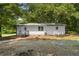 Charming single-story home showcasing a spacious yard with gravel driveway at 2871 Tucker Mill Sw Rd, Conyers, GA 30094